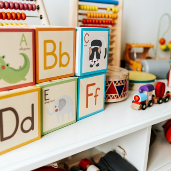 Set of kid toys on a white shelf